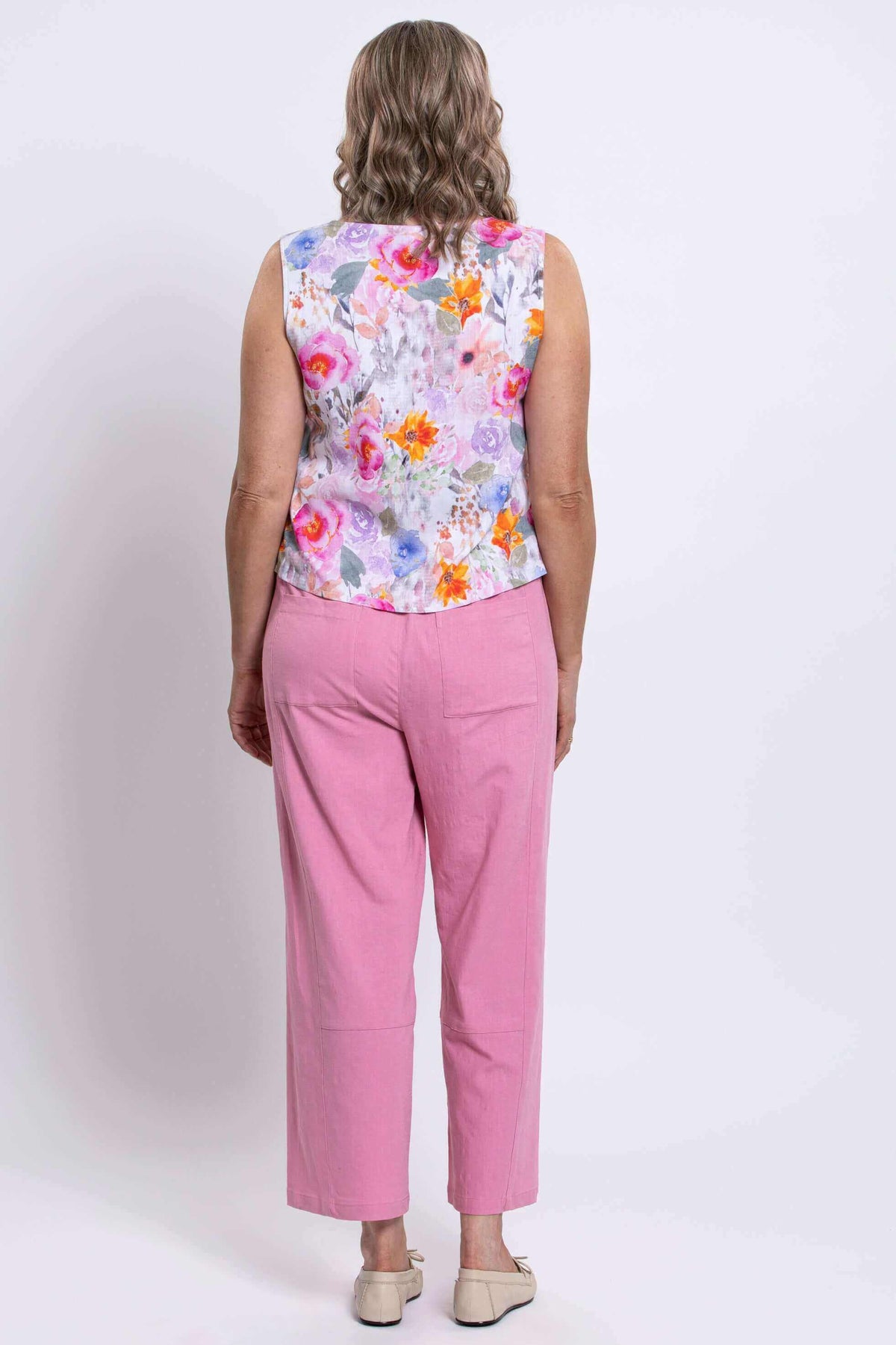 Back view of woman in floral bamboo-linen tank top and pink pants