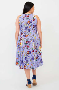 Back view of a woman in a sleeveless lilac floral A-line dress with flared skirt
