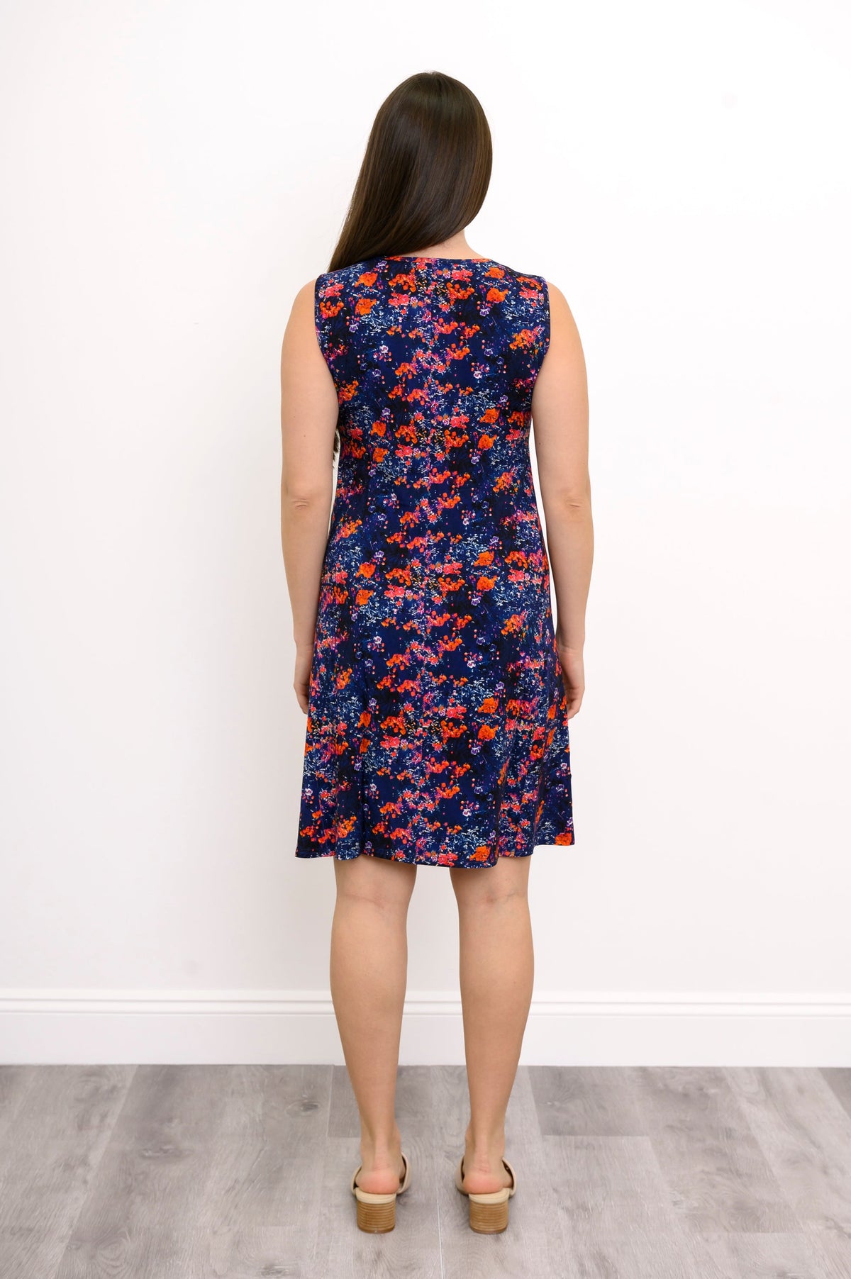 Back view of woman in navy floral sleeveless dress