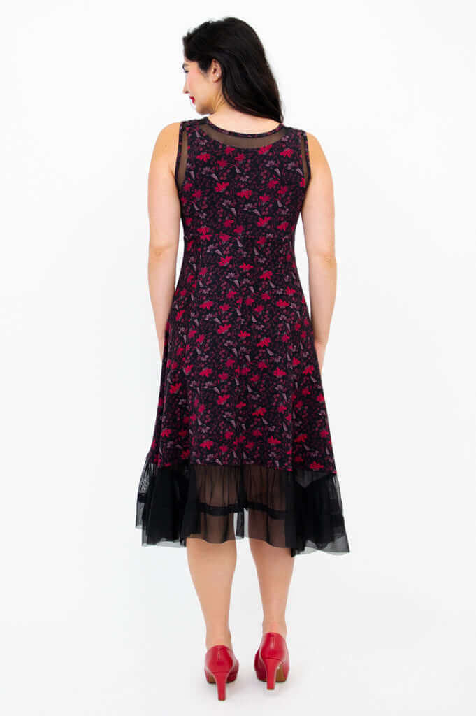 Back view of woman in sleeveless floral dress with mesh hem