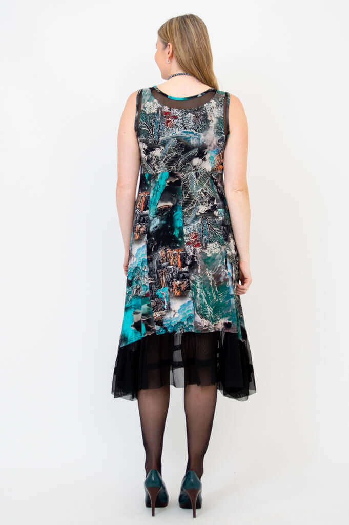 Back view of woman in sleeveless printed dress with mesh hem