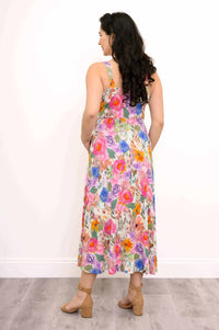 Back view of woman in a vibrant floral maxi dress showcasing the flowy skirt