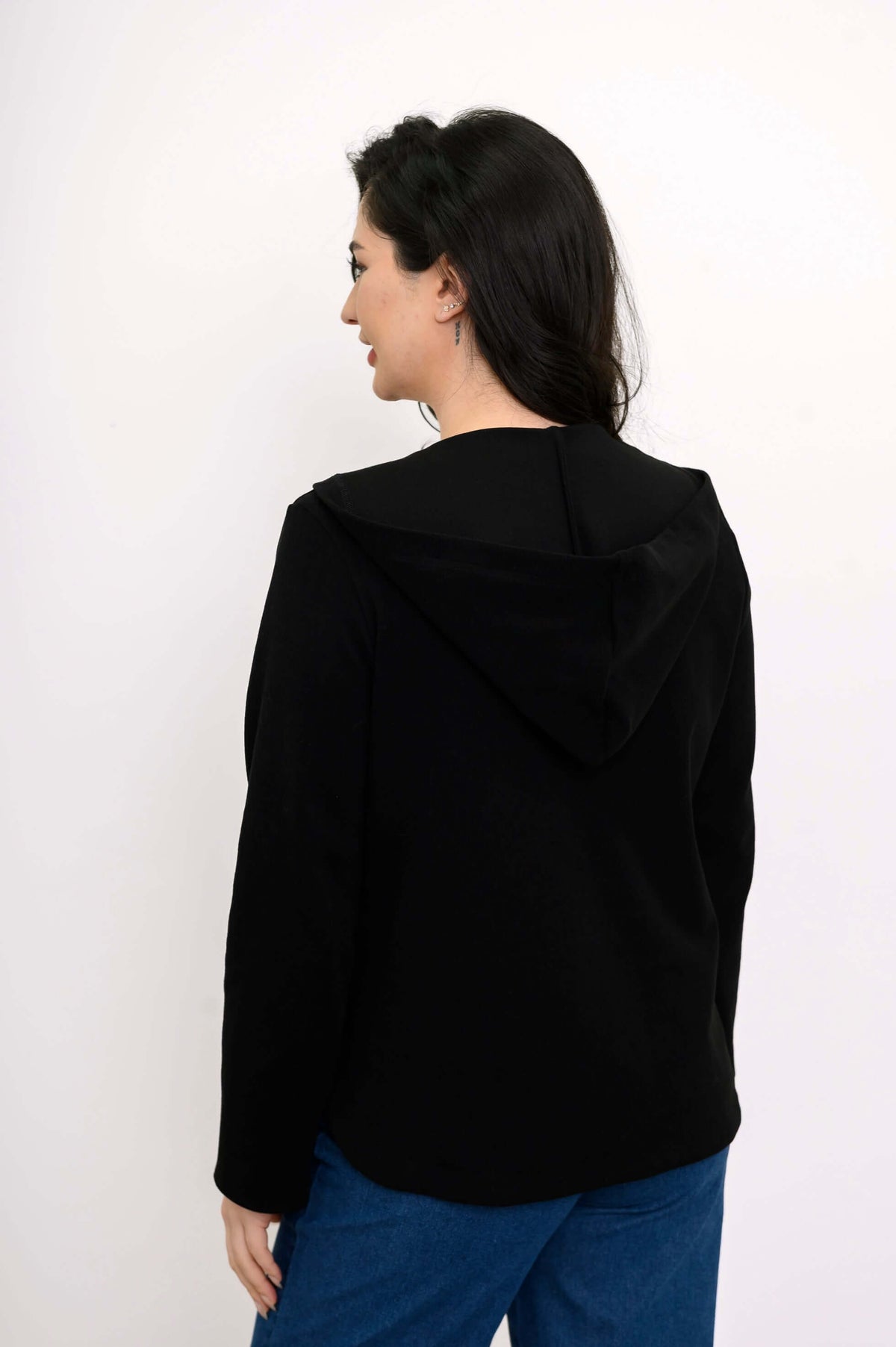 Back view of woman showing the hood and tailored design of the black Bowen jacket