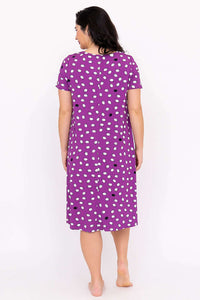 Back view of woman wearing a purple polka dot sleepshirt