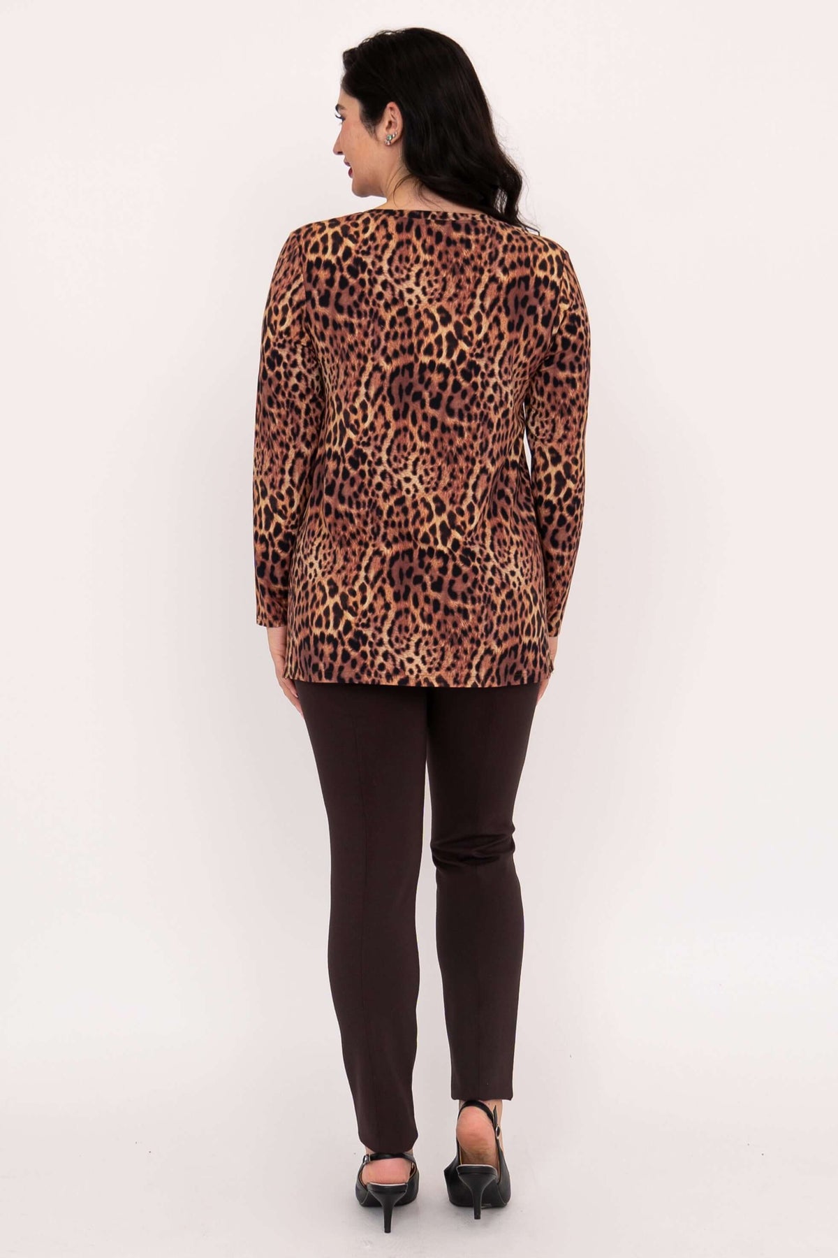 Back view of woman wearing leopard print tunic top and dark pants