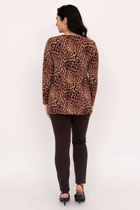 Back view of woman wearing leopard print tunic top and dark pants