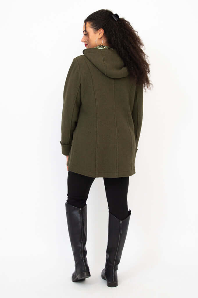 Back view of woman wearing olive green wool coat with hood