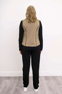 Back view of woman wearing tan Hartford Utility Vest and black pants