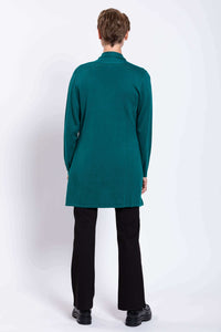 Back view of woman wearing teal cardigan over black pants