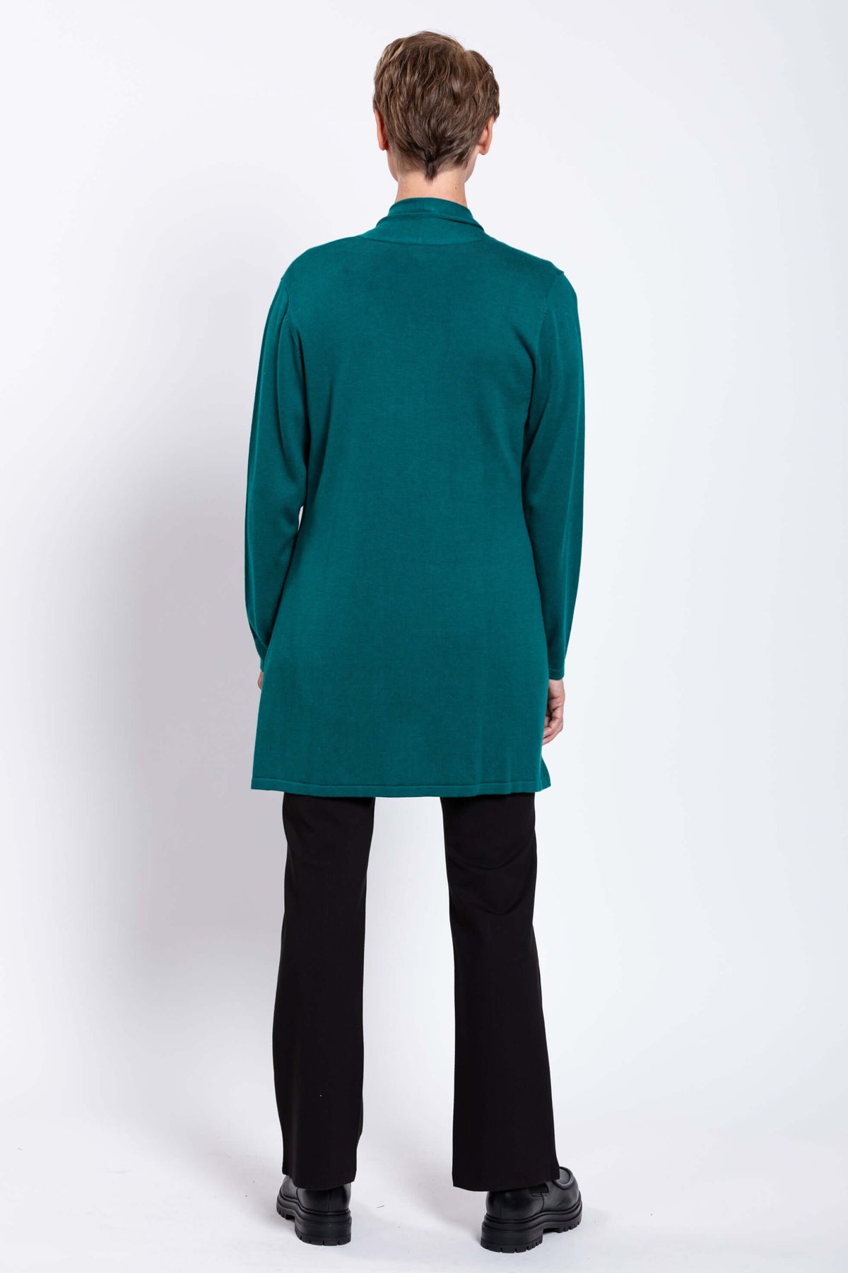 Back view of woman wearing teal open front cardigan