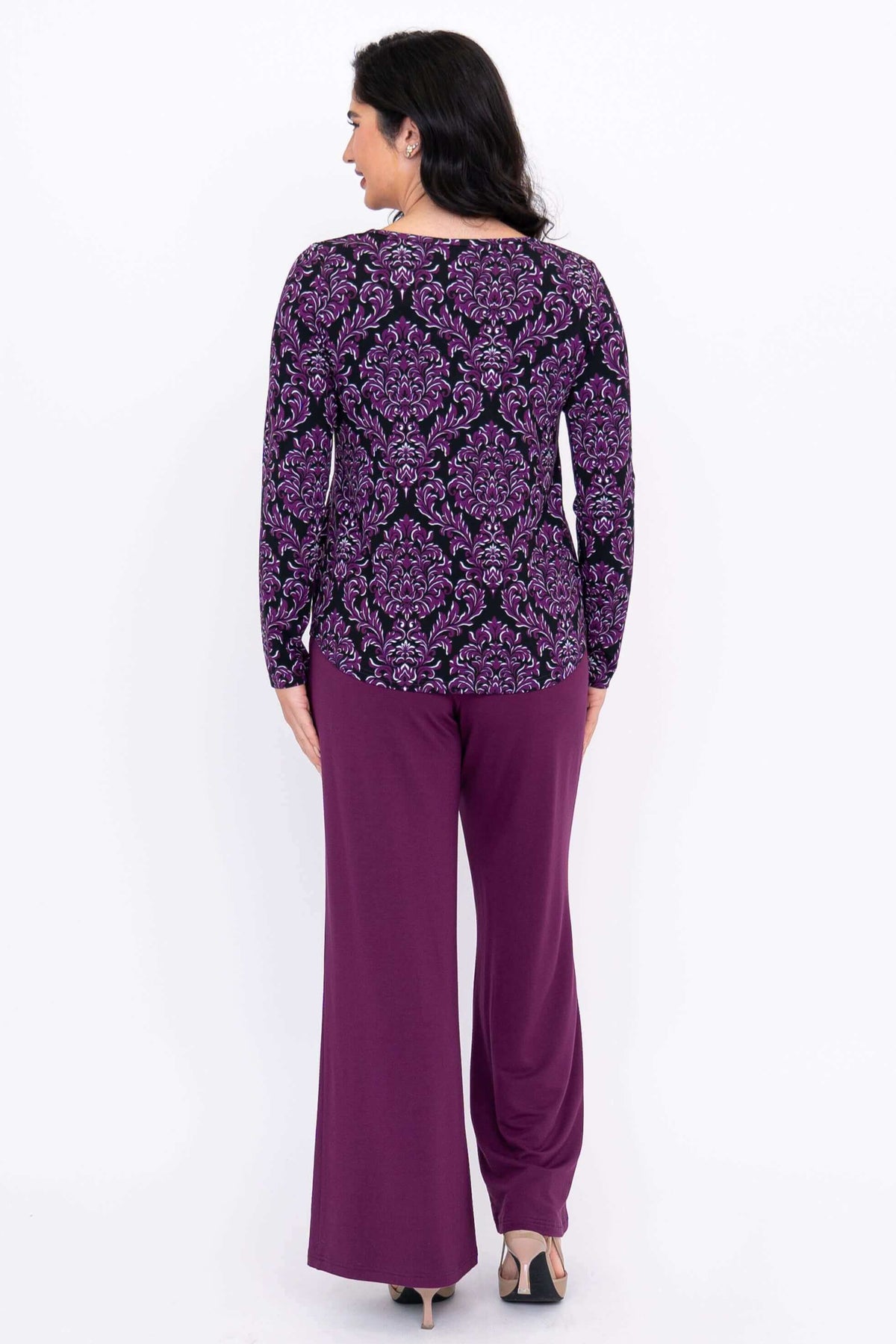 Back view of purple damask print long sleeve top paired with purple pants