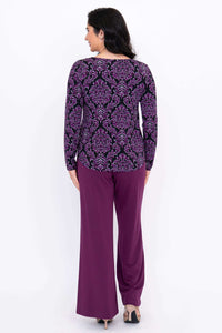 Back view of purple damask print long sleeve top paired with purple pants