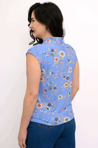 Back view of a woman in a blue floral sleeveless top showing the back collar details