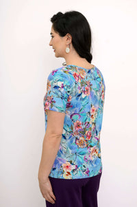 Back view of a woman showcasing the blue floral bamboo top