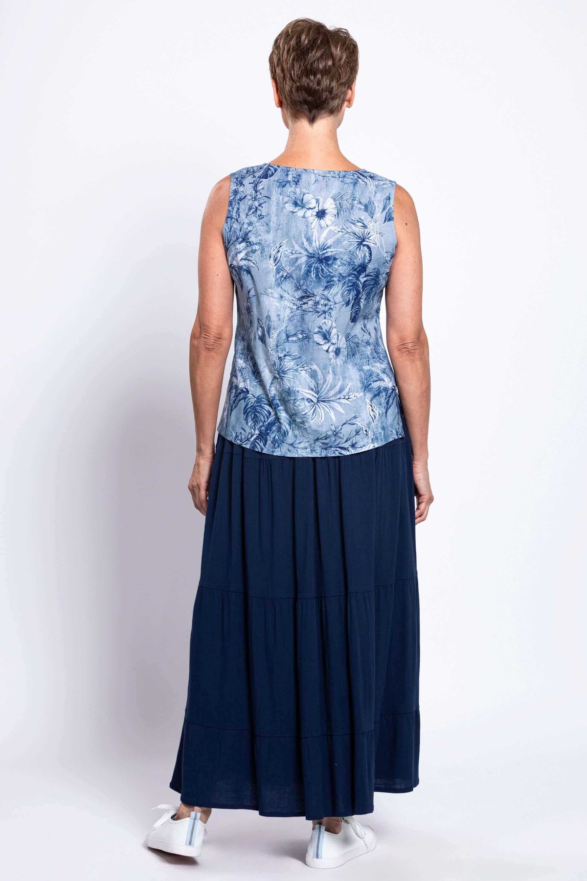Back view showing blue floral tank top and navy tiered skirt