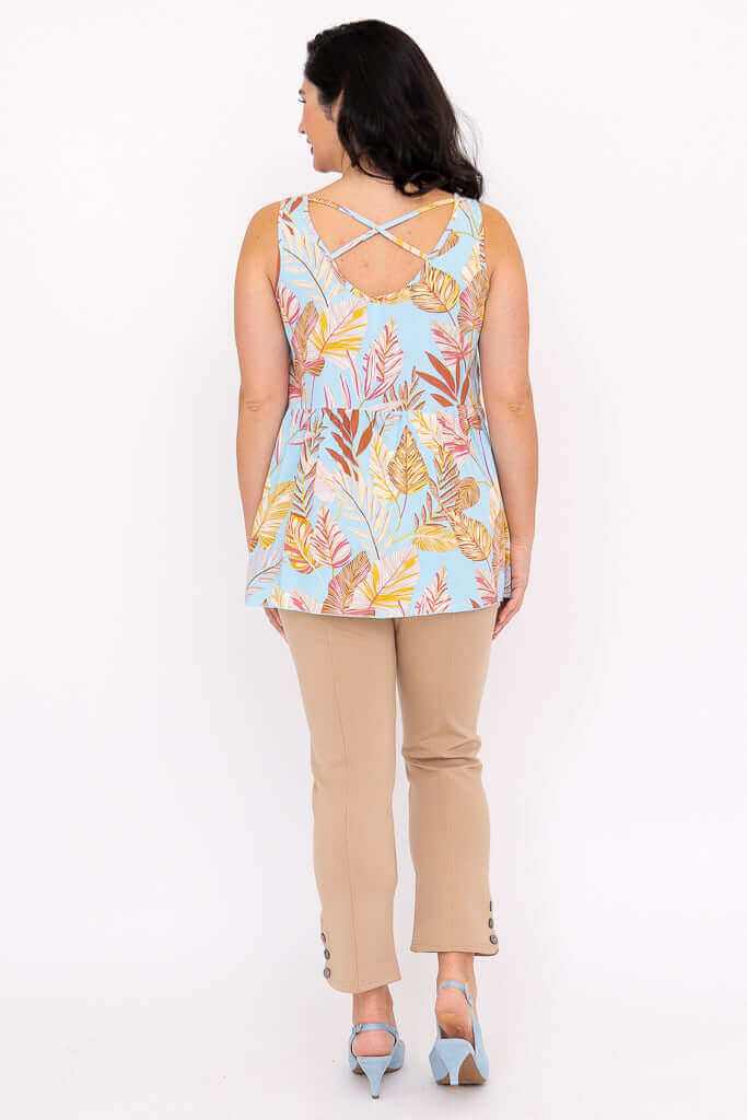 Back view of woman wearing blue leaf print tank top showing criss cross detail