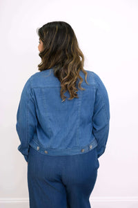Back view of a woman showing the design and fit of a denim jacket