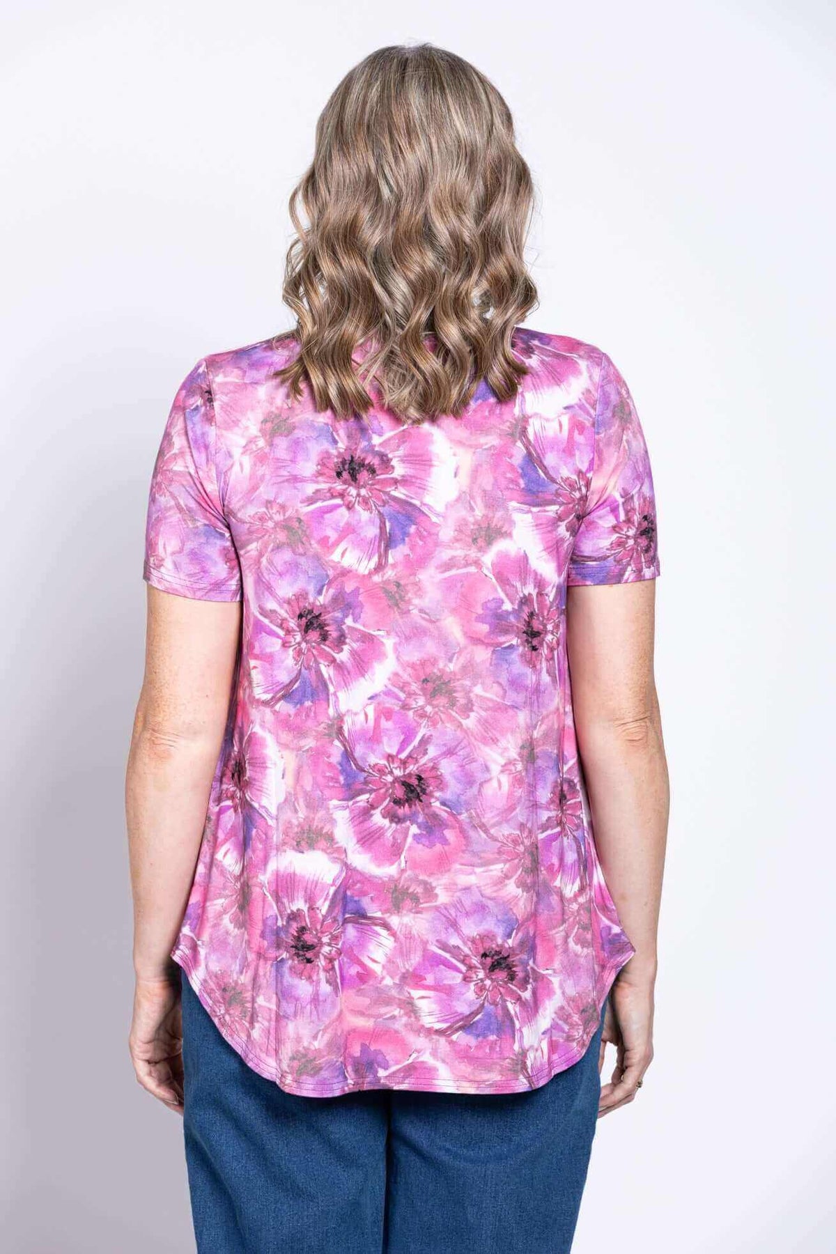Back view of woman in pink and purple floral V-neck bamboo top