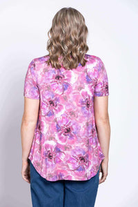 Back view of woman in pink and purple floral V-neck bamboo top