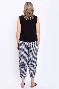 Back view of sleeveless black tank and checkered pants outfit