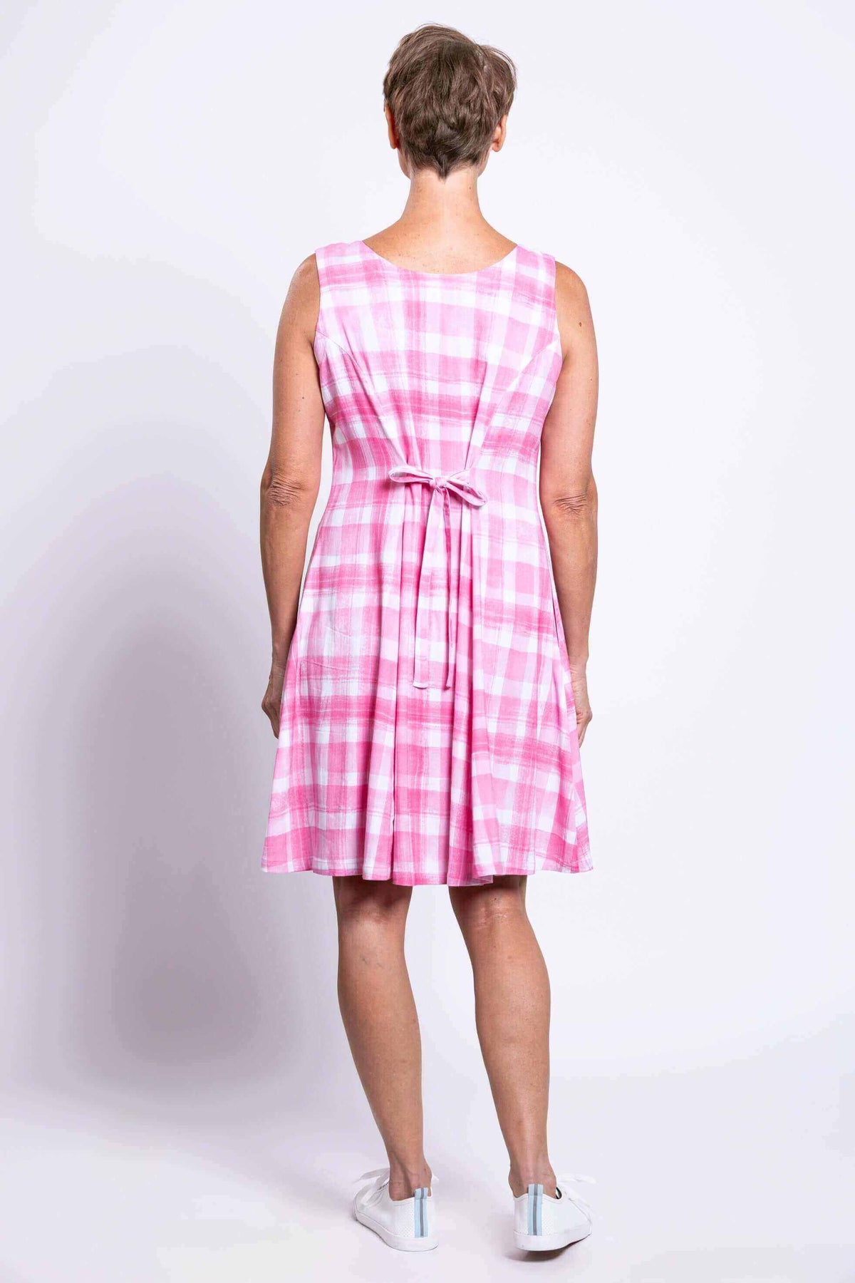 Back view showing tie-belt detail on a pink plaid sleeveless A-line dress