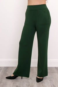 Close-up front view of women's relaxed-fit dark green knit trousers with a flattering flat waistband.