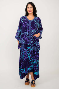 Woman wearing purple bamboo print tunic top over matching maxi skirt and sandals