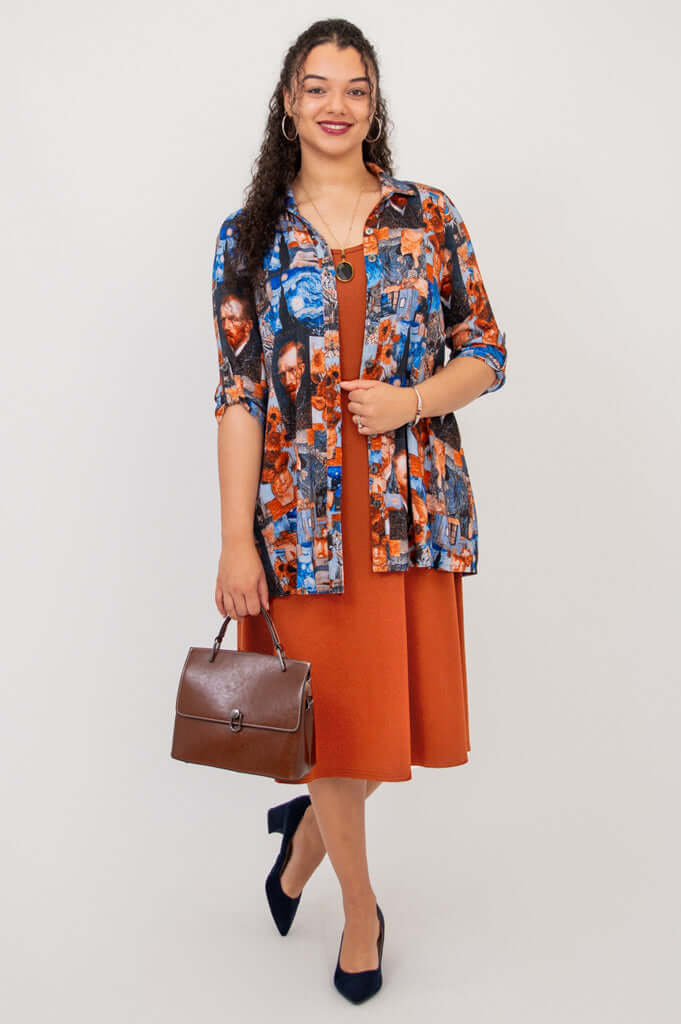 Becca dress styled under a colorful printed shirt with brown handbag and navy heels