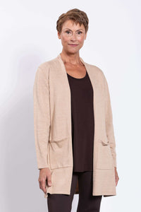 Woman wearing a beige open-front cardigan over a brown top, close-up view