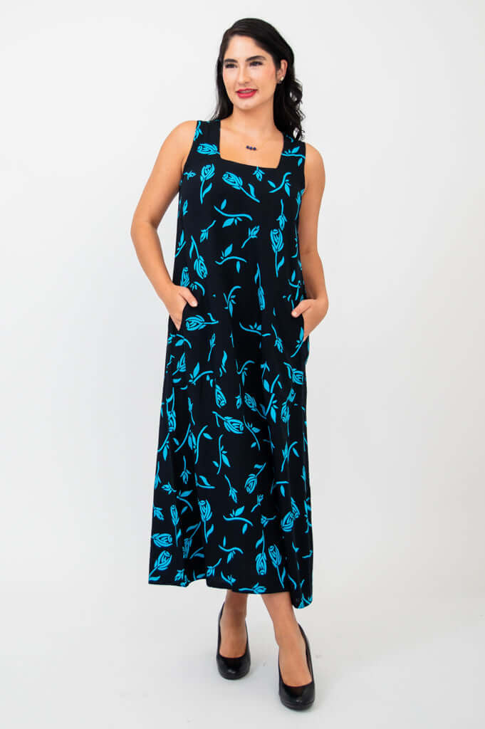 Model in sleeveless black maxi dress with turquoise floral design