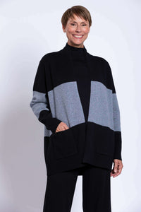 Woman wearing a black and grey colour block open front sweater with shawl collar