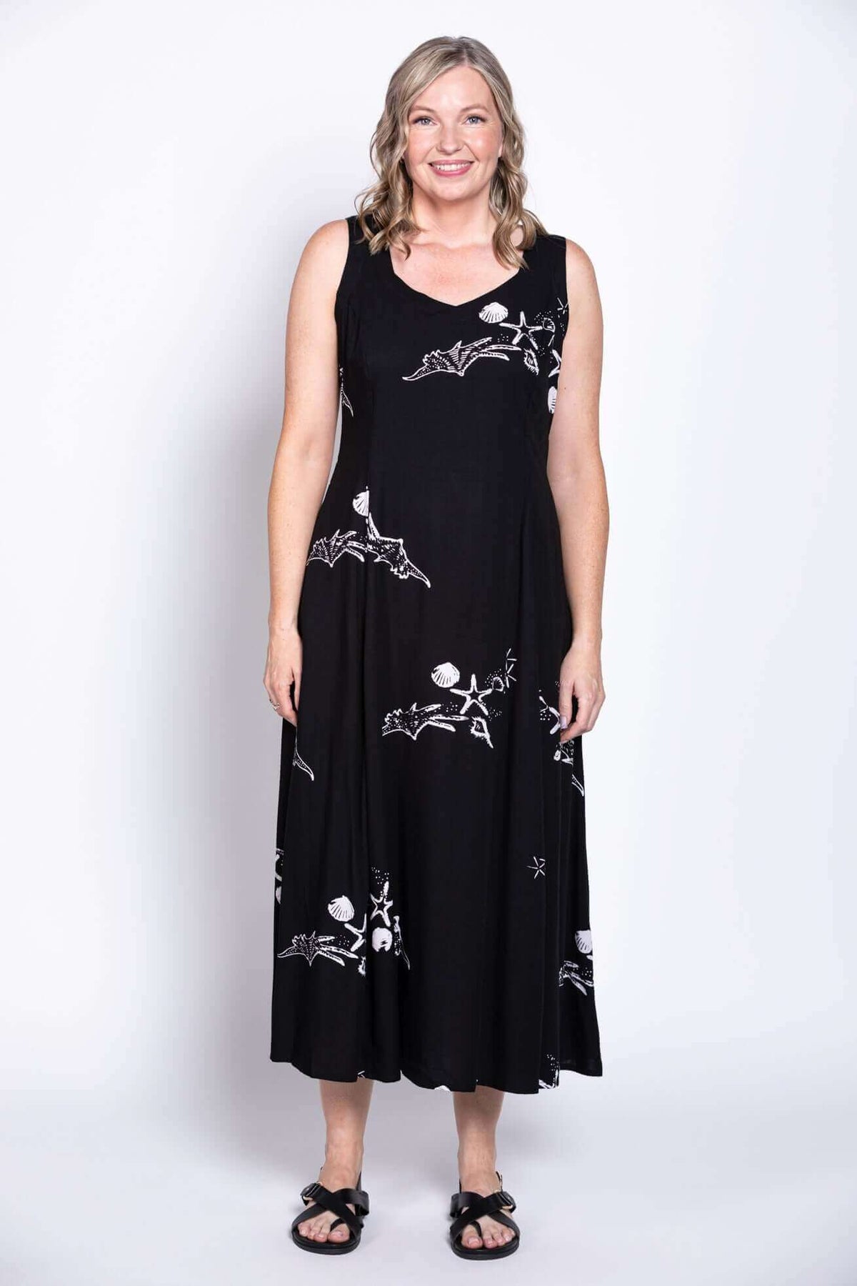 Black summer dress with white decorative patterns, displayed on model