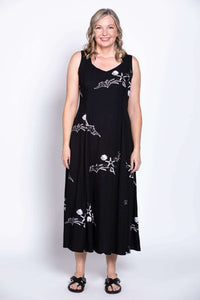 Black summer dress with white decorative patterns, displayed on model