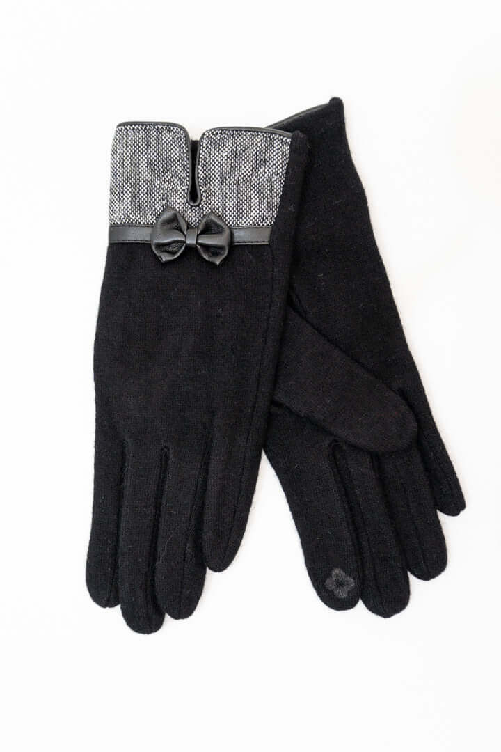 Pair of black wool gloves with textured cuffs and bow detail on white background