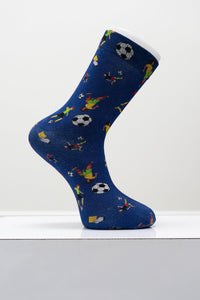 Blue crew dress sock with soccer ball graphics shown on a white display foot mannequin against a studio backdrop.