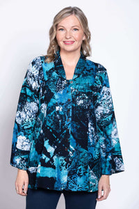 Woman wearing a blue and black abstract print blouse with mandarin collar and buttons, front view