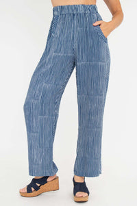 Woman wearing blue and white striped rayon pants with elastic waistband and side pockets