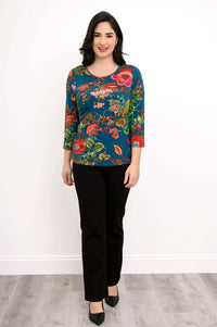 Woman modeling blue bamboo tee with vibrant floral print, front full-length view