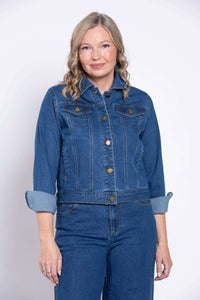 Woman with rolled-up sleeves on a blue denim jacket, front view