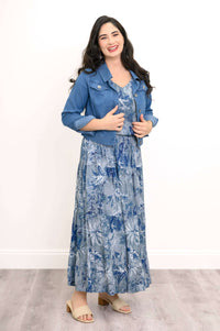 Woman in blue floral tank top, matching skirt, and blue denim jacket