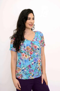 Woman wearing a blue floral bamboo top shown at a front angle