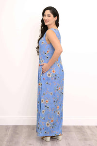Side view of model wearing blue floral sleeveless maxi dress with pockets