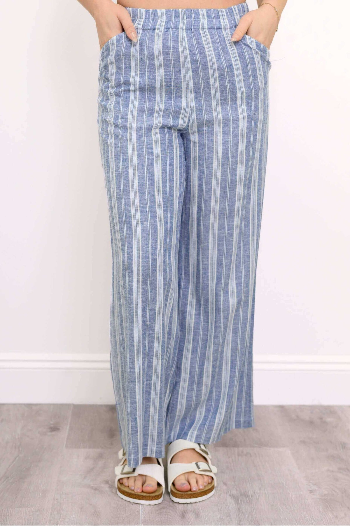 Parker Pant in blue stripe shown with hands in front pockets, wide-leg style