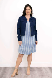 Woman in blue striped shift dress with navy jacket, front view