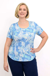 Woman wearing a blue watercolor print short sleeve tee with a rounded hem