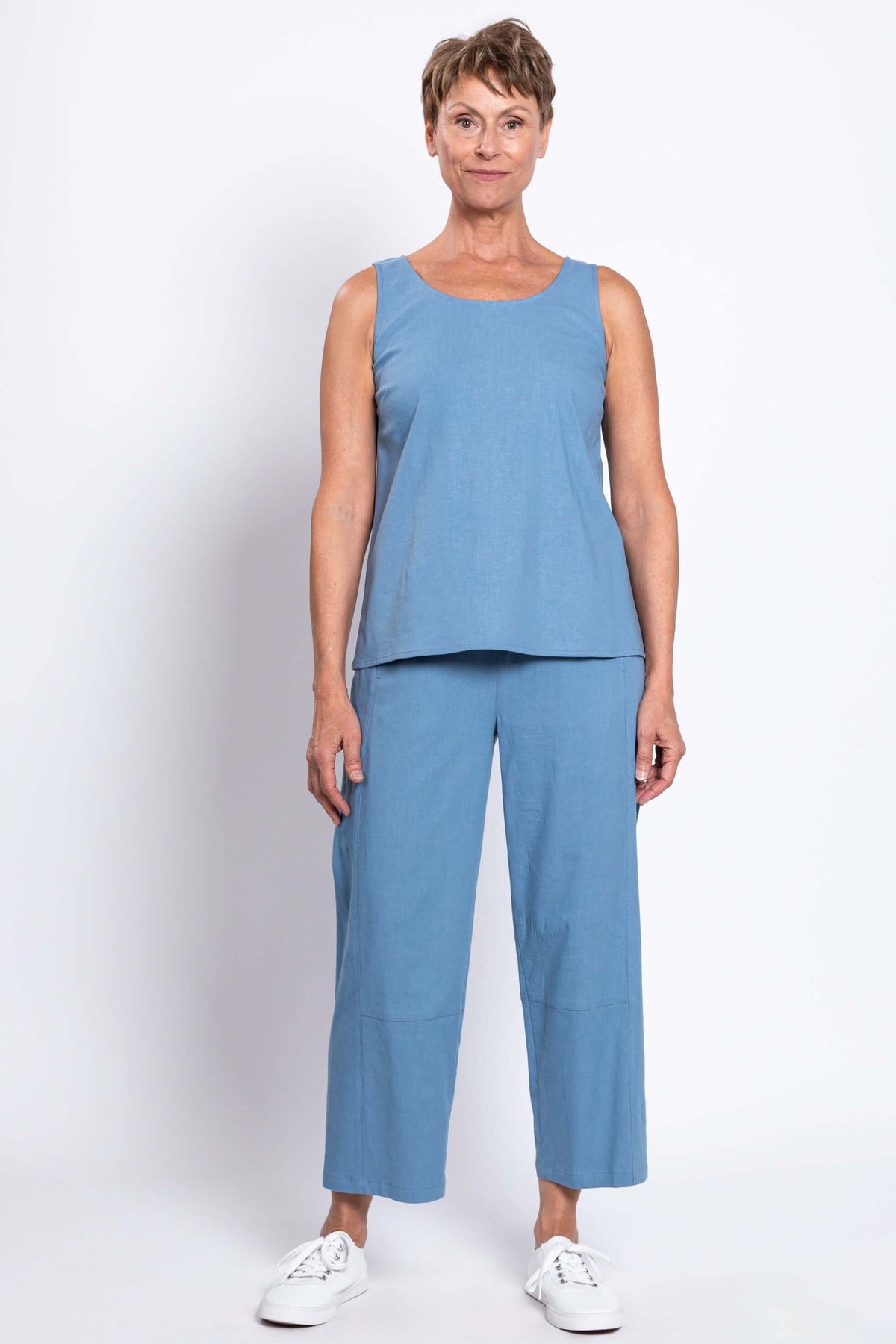 Front view of person in light blue sleeveless top and cropped pants set