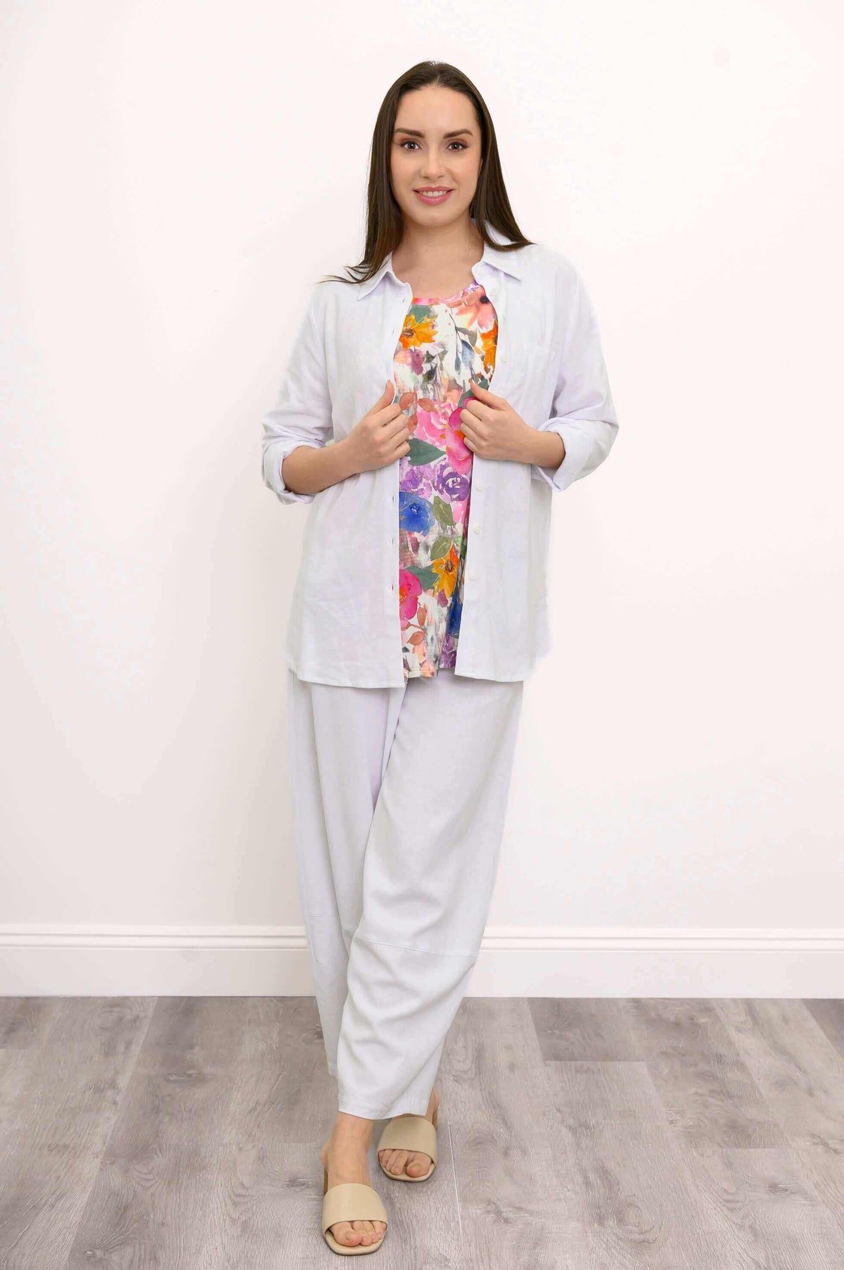 Model in Boardwalk Pants, floral top, and white shirt, front view