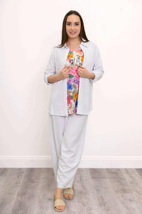 Model in Boardwalk Pants, floral top, and white shirt, front view