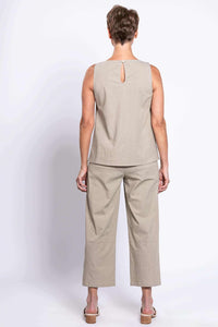 Back view of woman in cropped beige Boardwalk Pants and sleeveless top, showing keyhole detail