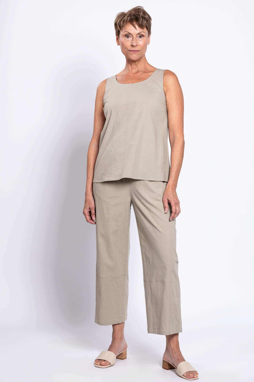 Woman modeling cropped beige Boardwalk Pants and matching sleeveless top, standing front view